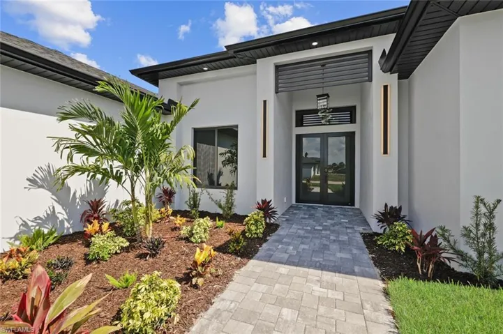 Doorway to property featuring french doors and stucco siding