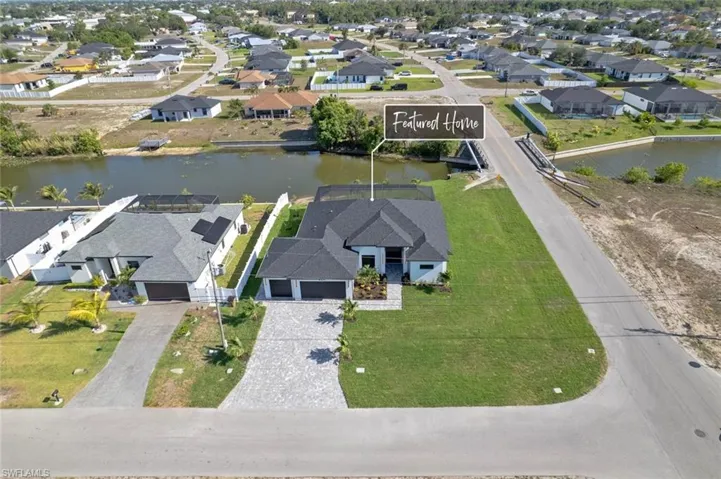 Aerial perspective of suburban area featuring a large body of water