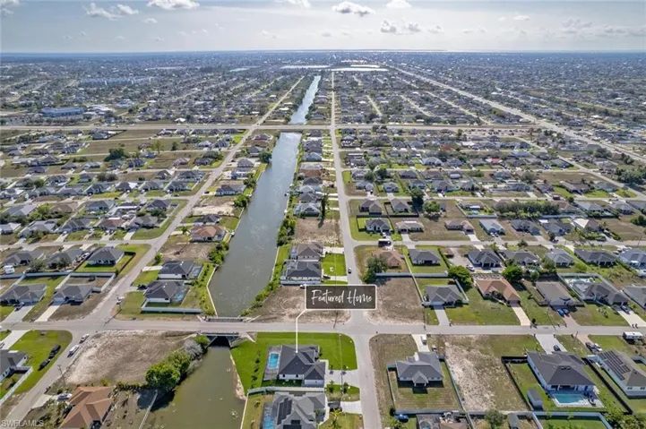 Aerial view of property's location featuring nearby suburban area and a nearby body of water