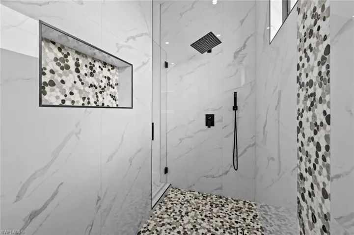 Full bathroom featuring a marble finish shower