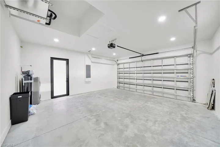 Garage with recessed lighting and electric panel