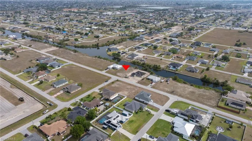 Birds eye view of property with a residential view and a water view