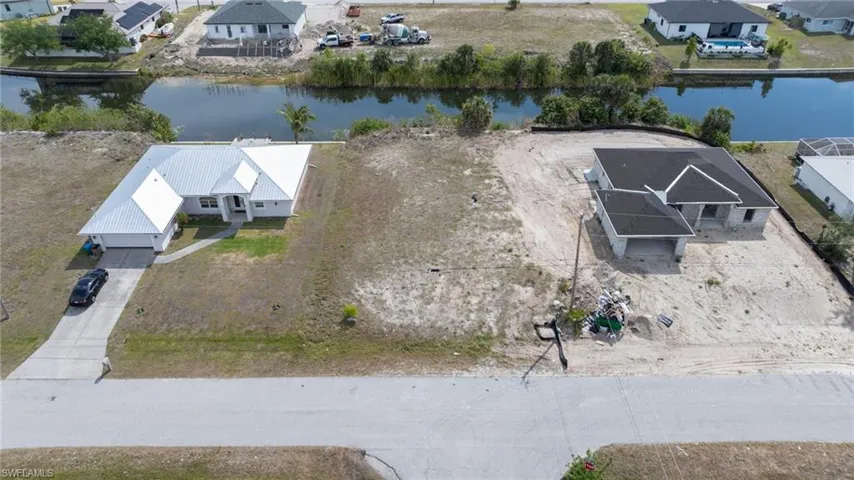 Birds eye view of property with a residential view and a water view