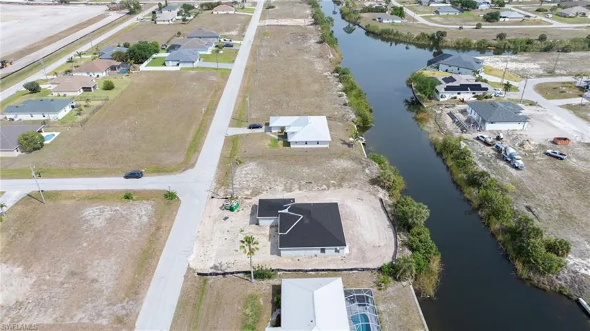 Drone / aerial view with a residential view and a water view