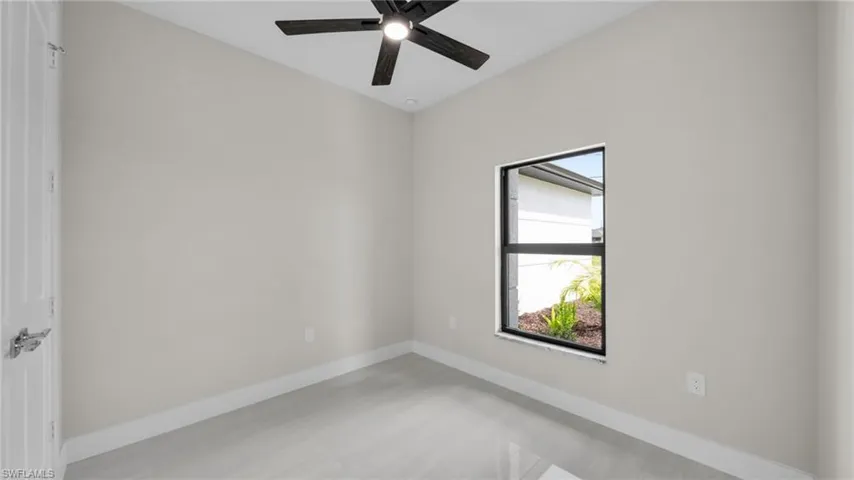 Spare room with baseboards and ceiling fan