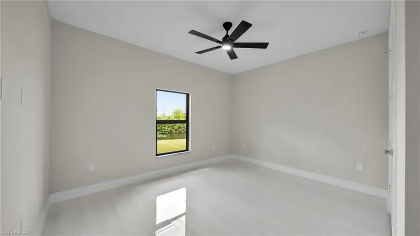 Unfurnished room featuring baseboards and a ceiling fan