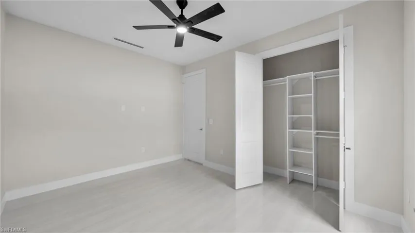 Unfurnished bedroom featuring ceiling fan and a closet