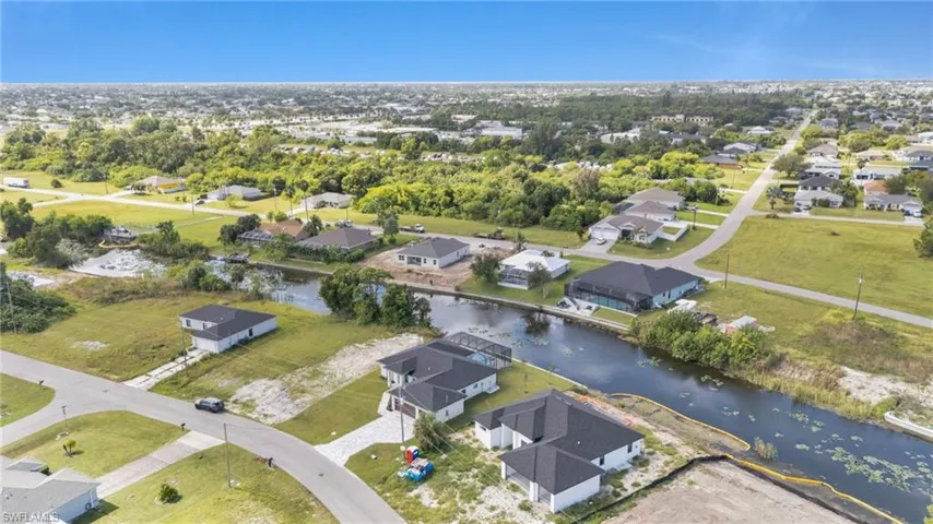 Aerial overview of property's location featuring nearby suburban area and a large body of water