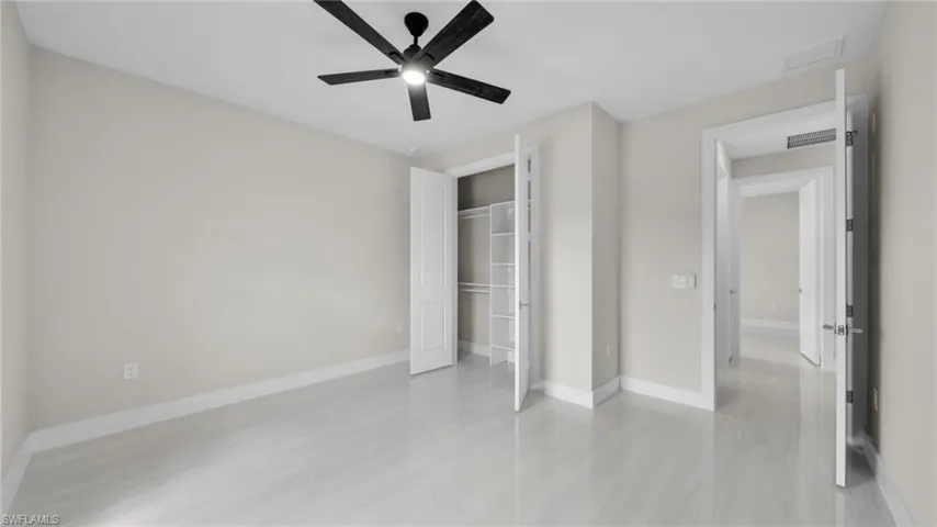 Unfurnished bedroom featuring a ceiling fan and a closet