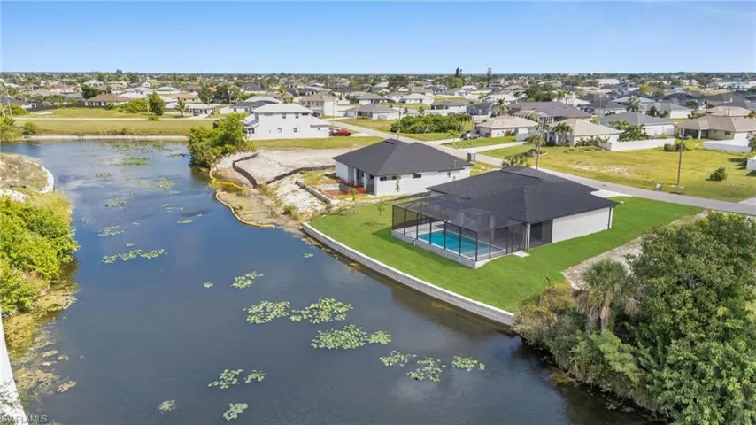 Aerial perspective of suburban area with a nearby body of water