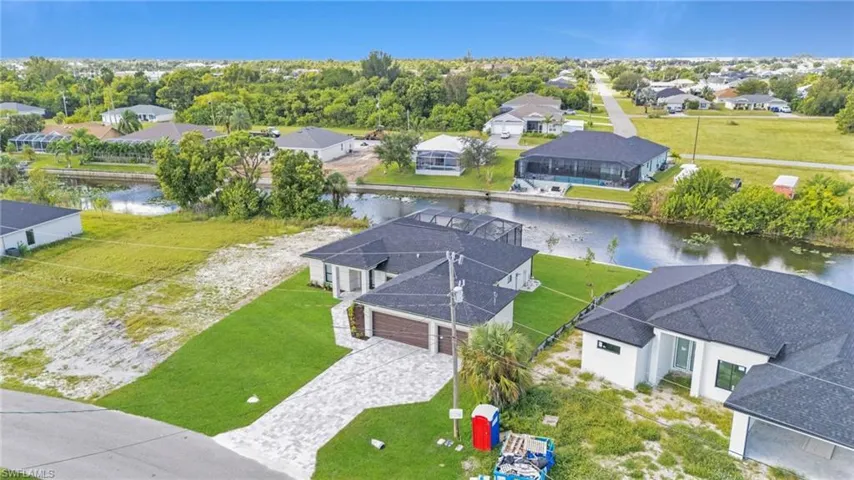 Aerial view of residential area featuring a nearby body of water