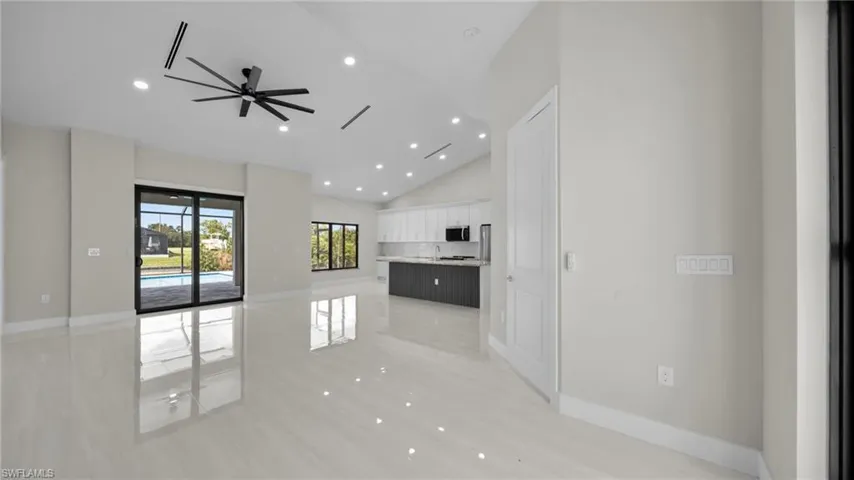 Unfurnished living room with recessed lighting, a ceiling fan, high vaulted ceiling, and light wood finished floors