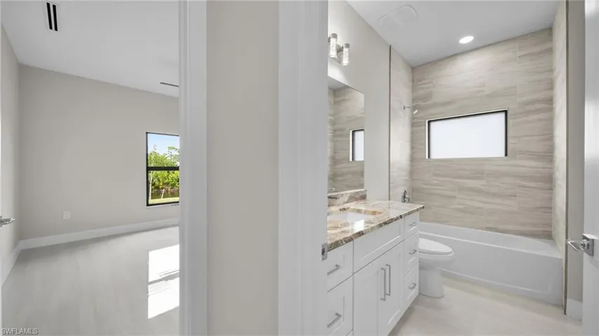 Full bathroom featuring bathing tub / shower combination and vanity