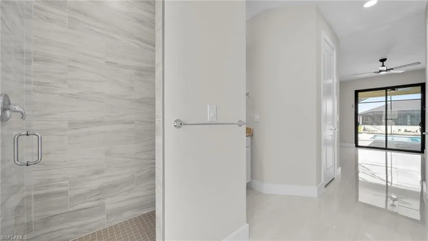 Full bathroom with a shower stall, a ceiling fan, light tile patterned floors, and recessed lighting