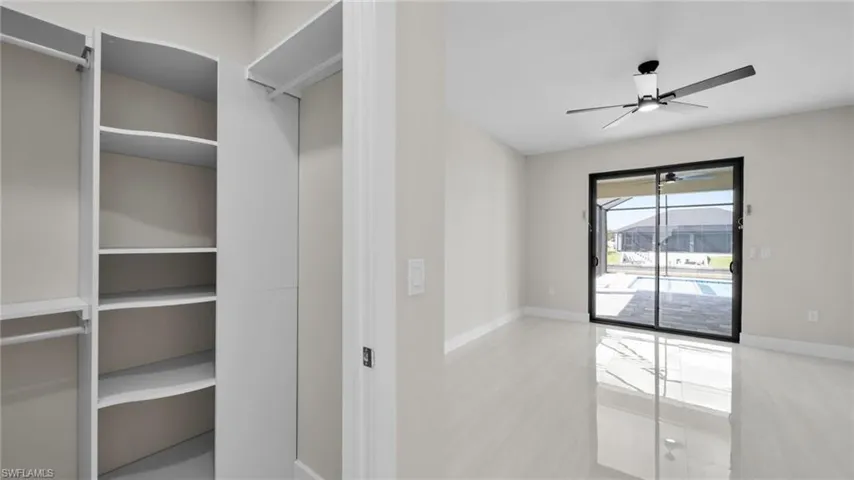 Walk in closet with ceiling fan