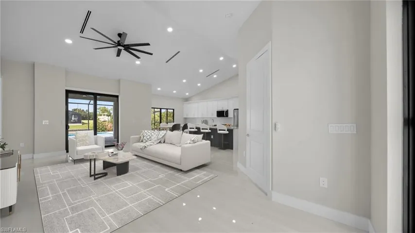 Living room featuring recessed lighting, ceiling fan, high vaulted ceiling, and light wood-style floors