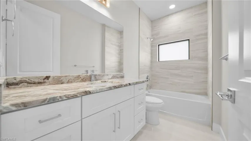 Bathroom with  shower combination, vanity, recessed lighting, and light wood-style floors
