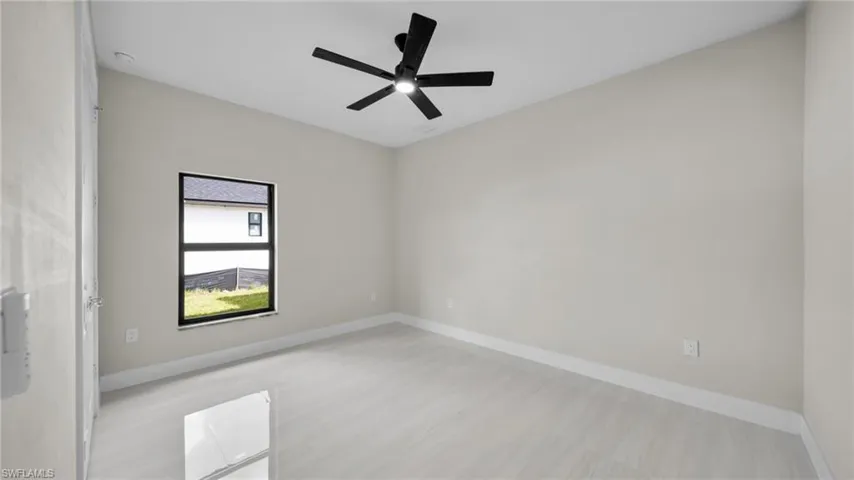 Empty room featuring baseboards and ceiling fan