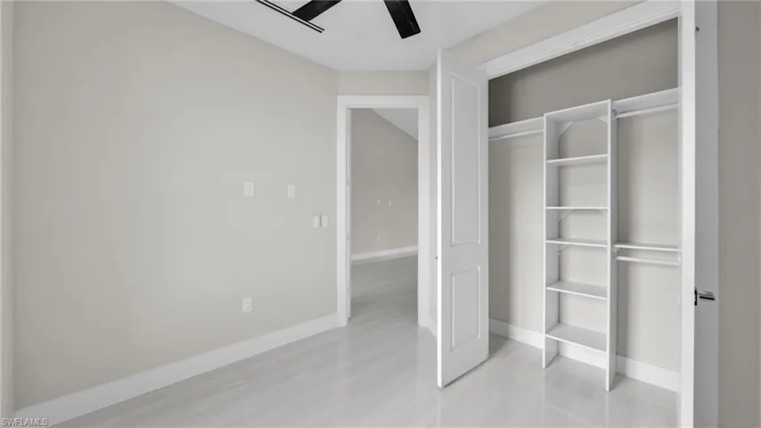 Unfurnished bedroom featuring ceiling fan, a closet, and light tile patterned flooring