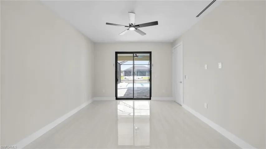 Spare room featuring a sunroom and a ceiling fan