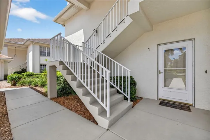 Doorway to property featuring stucco siding