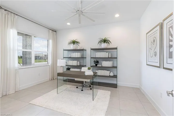 Office area with ceiling fan and light tile floors