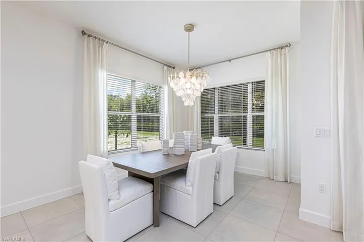 Dining room featuring a chandelier and light tile floors