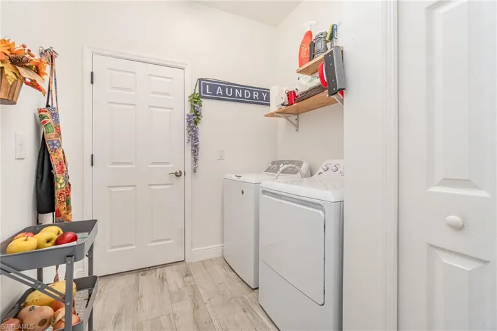 Laundry room with light wood-style flooring and washer and dryer