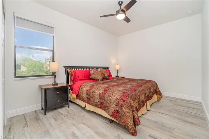 Bedroom with light wood-style floors and a ceiling fan