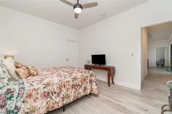 Bedroom with light wood-style flooring and ceiling fan