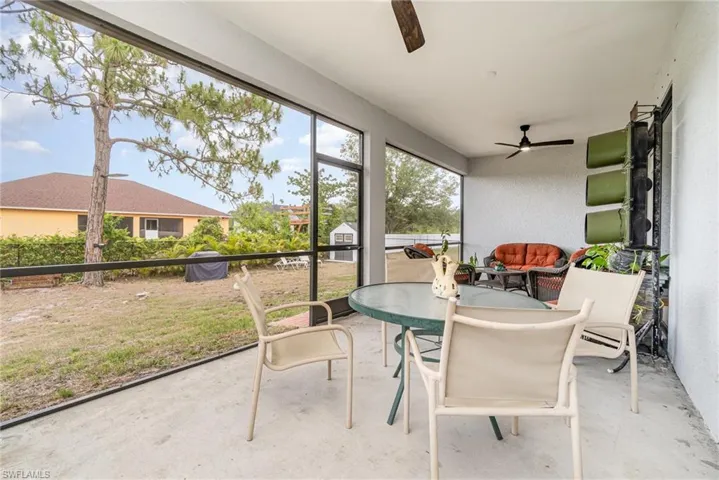Sunroom with ceiling fan and outdoor dining area