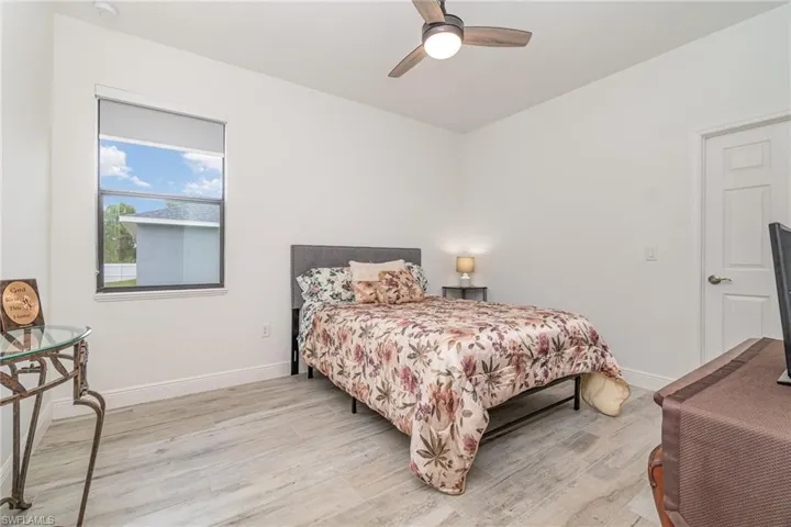 Bedroom with wood finished floors and a ceiling fan