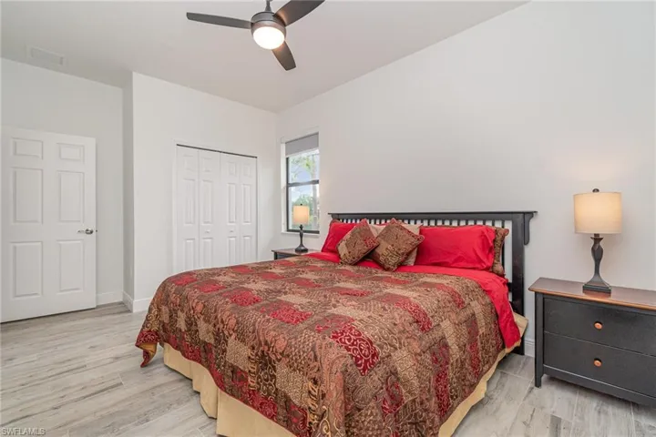 Bedroom featuring light wood finished floors, a closet, and ceiling fan