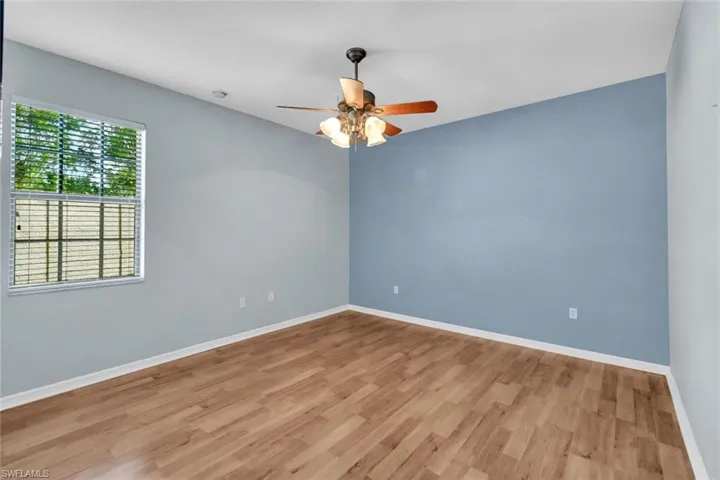 Guest Bedroom featuring wood like flooring and ceiling fan