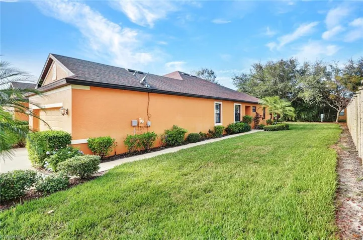 View of property exterior featuring a garage and a yard