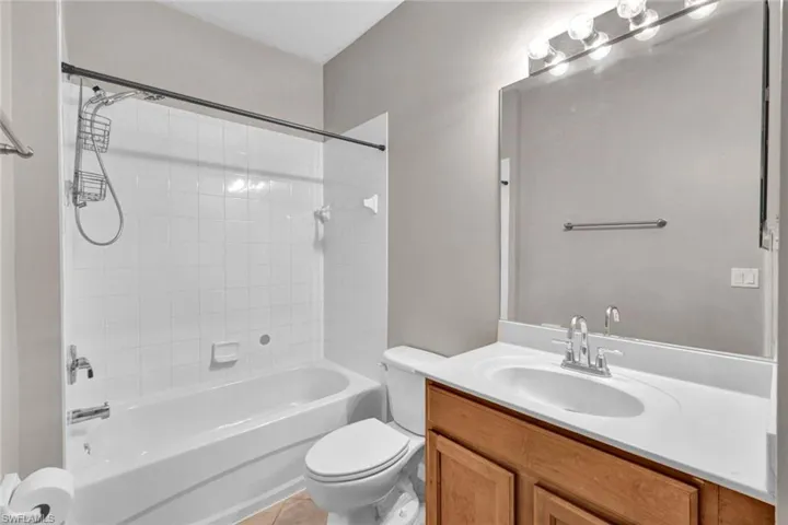 Full bathroom vanity featuring updated fixtures, shower / bath combo