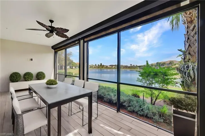 Sunroom / solarium with a water view and ceiling fan