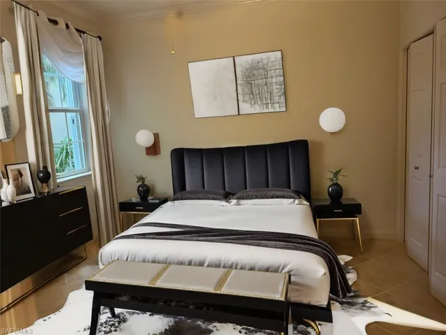 Bedroom featuring tile flooring and ornamental molding