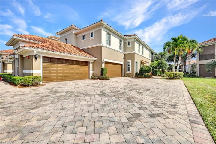 Long Paver driveway, lakefront building with large green area