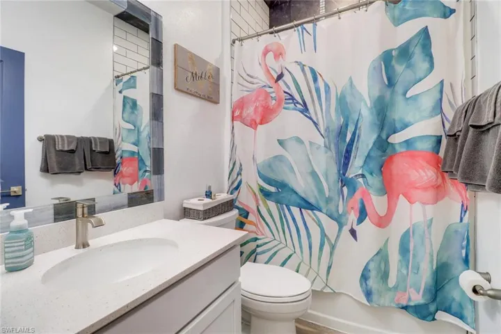 Full bathroom featuring vanity, toilet, and shower / bath combo