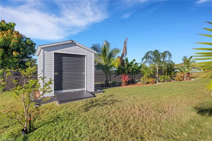 View of yard featuring a storage unit