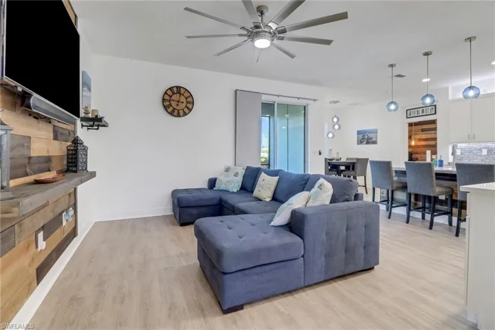 Living room featuring ceiling fan and light hardwood / wood-style flooring