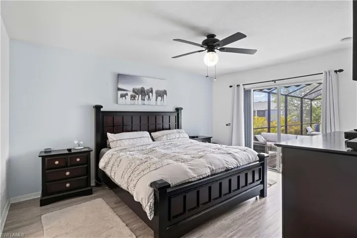 The primary bedroom offers easy access to the spa through sliding glass doors, allowing you to step directly into your private outdoor retreat.