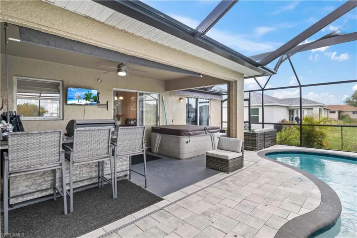 The outdoor space features a stunning pool complemented by a separate, luxurious spa, creating the perfect setting for relaxation and entertainment.