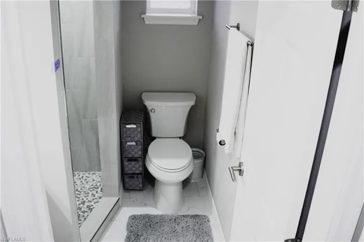 Bathroom featuring walk in shower and toilet