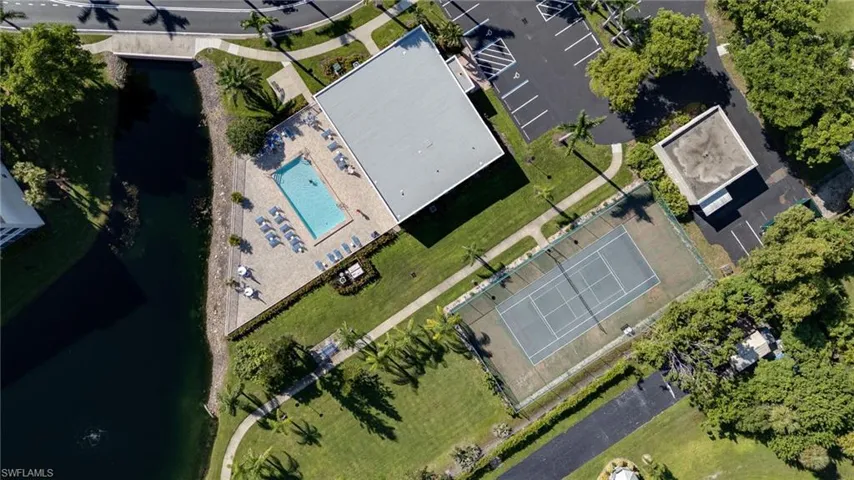 Bird's eye view of a nearby body of water and a pool