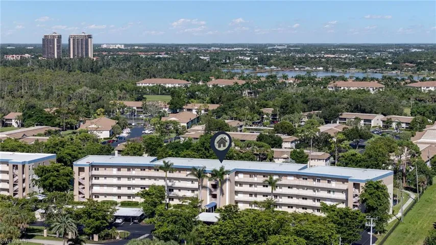Aerial view of apartment complex / building and a nearby body of water