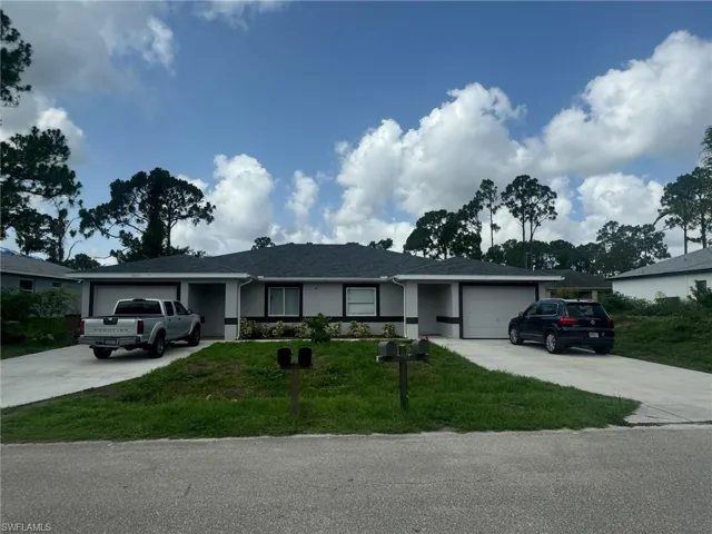 Ranch-style home with an attached garage, concrete driveway, and a front yard