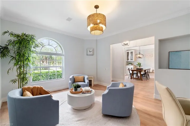 Natural light flows abundantly into the den/sitting area right off of the main entryway