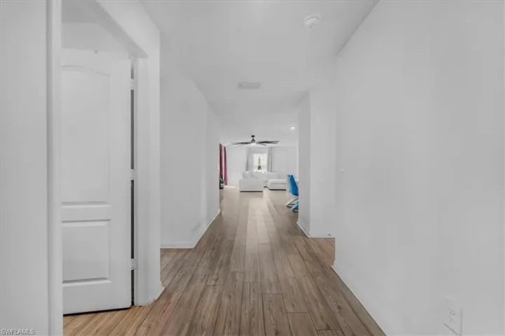 Hallway with light wood finished floors and baseboards